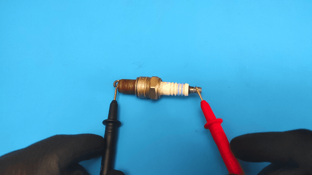 place probes on ends of spark plug