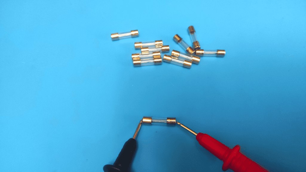 place multimeter probes on fuse ends
